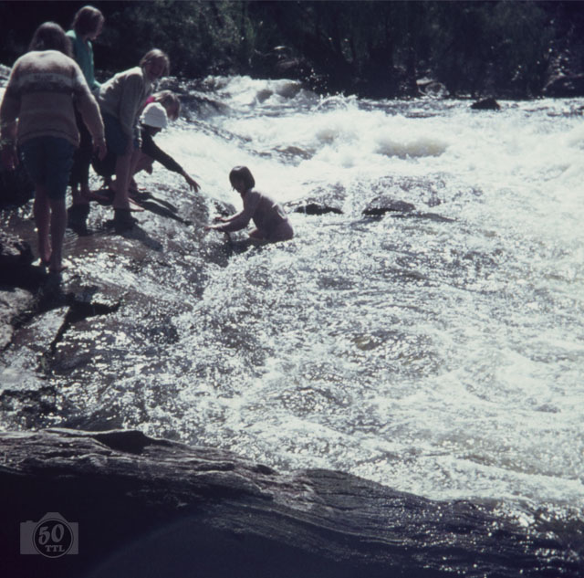 girl climbing out of stream